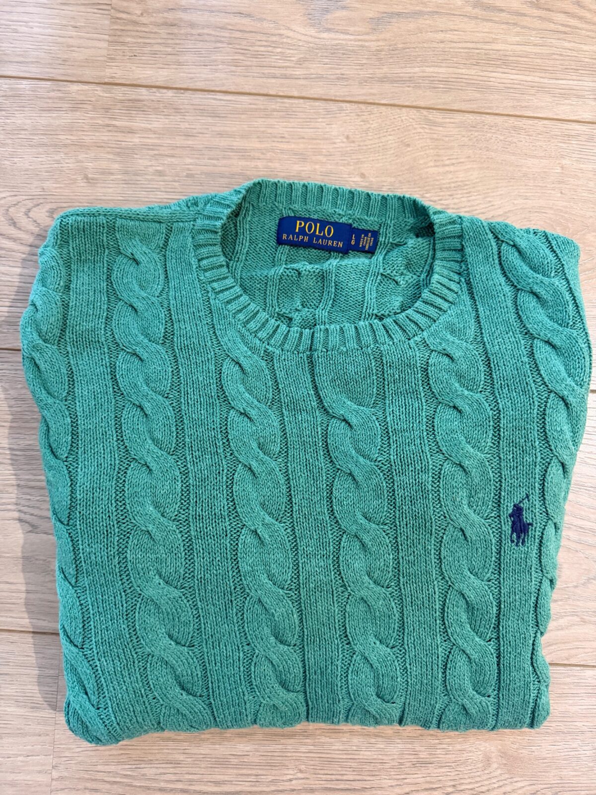Polo Ralph Lauren green cable-knit jumper after long-term wear and washing, photographed flat by QWD