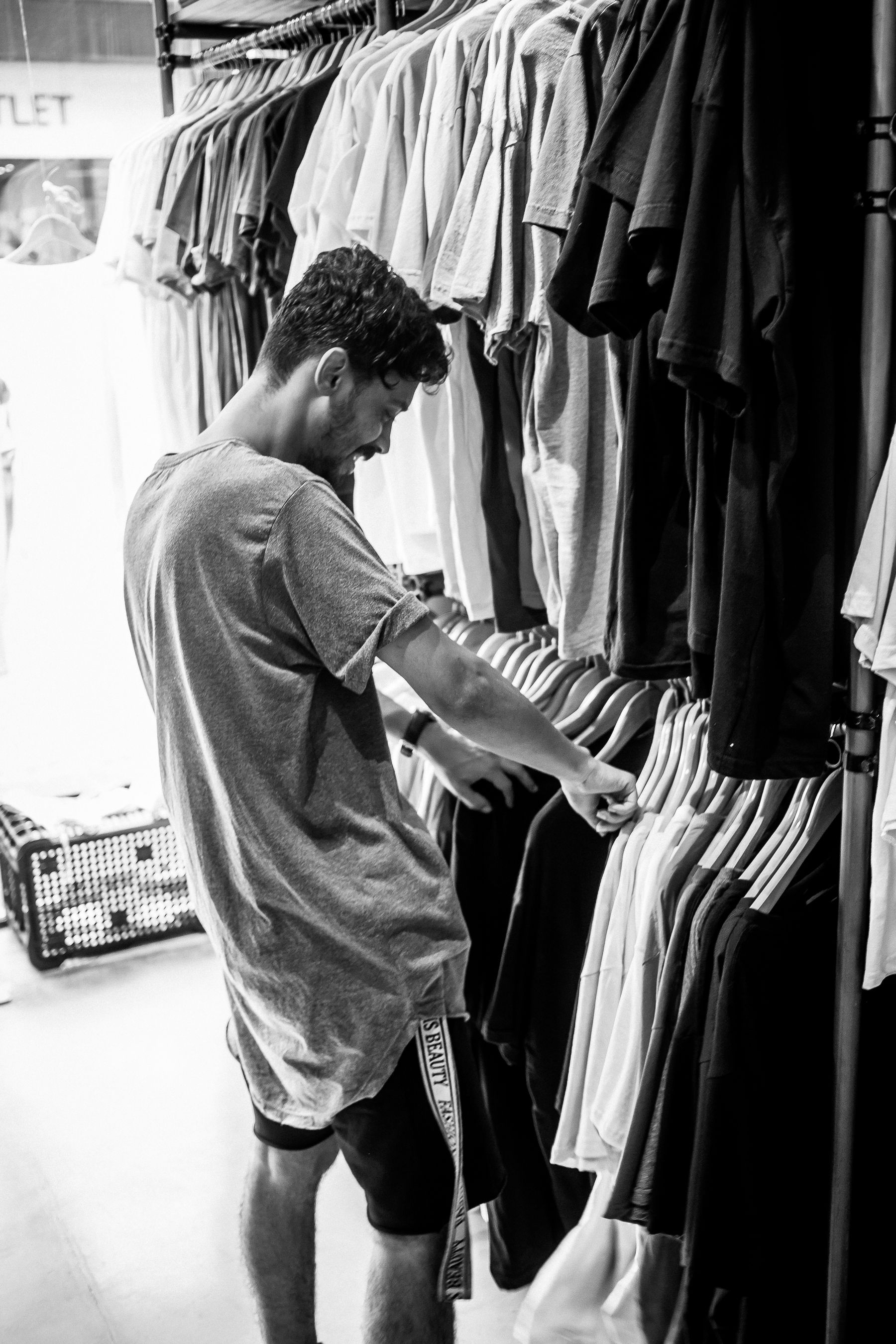 A shopper examining the construction of a garment